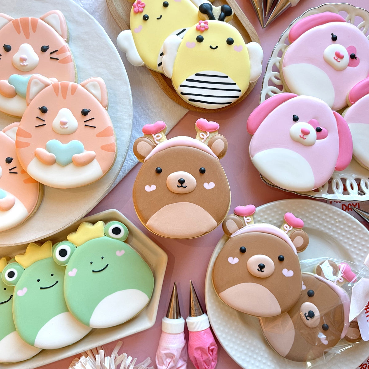 Cute brown bear-shaped cookies with pink heart accents and white paw details from the squishie valentine’s decorating kit