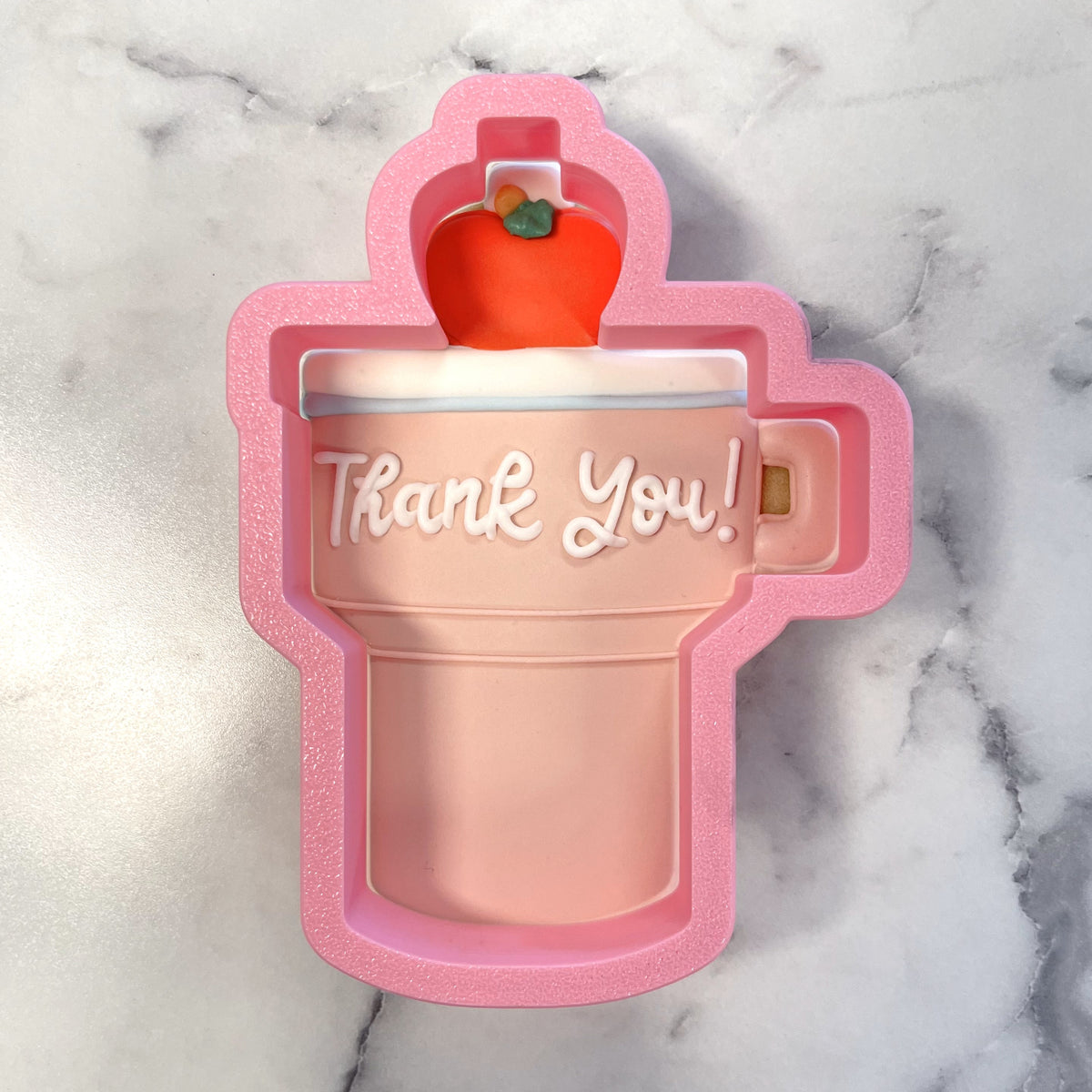 Pink silicone teacher tumbler cookie cutter mold featuring a red apple and thank you inscription