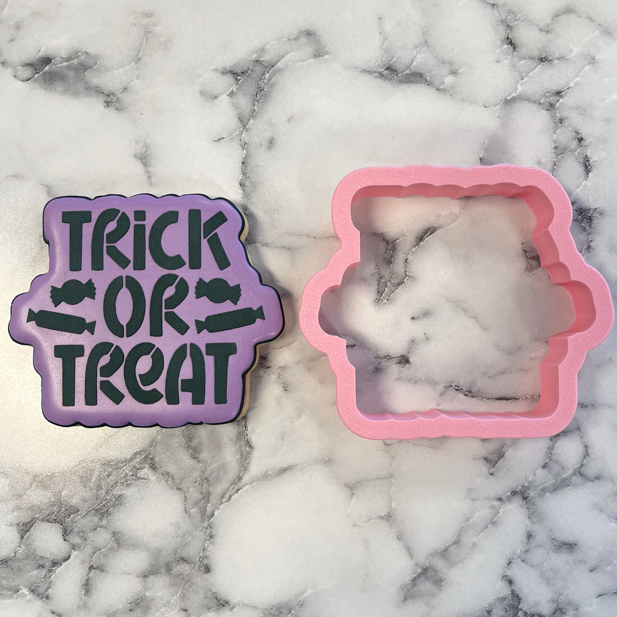 Purple silicone trick or treat plaque cookie cutter with candy stencil and pink ghost-shaped mold for baking use