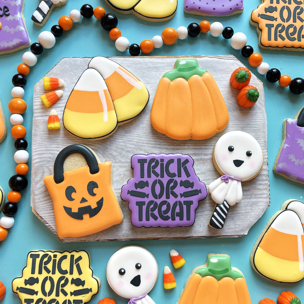 Orange pumpkin-shaped cookie with green stem and smooth icing made using Trick or Treat Plaque Flour Box Club cutter
