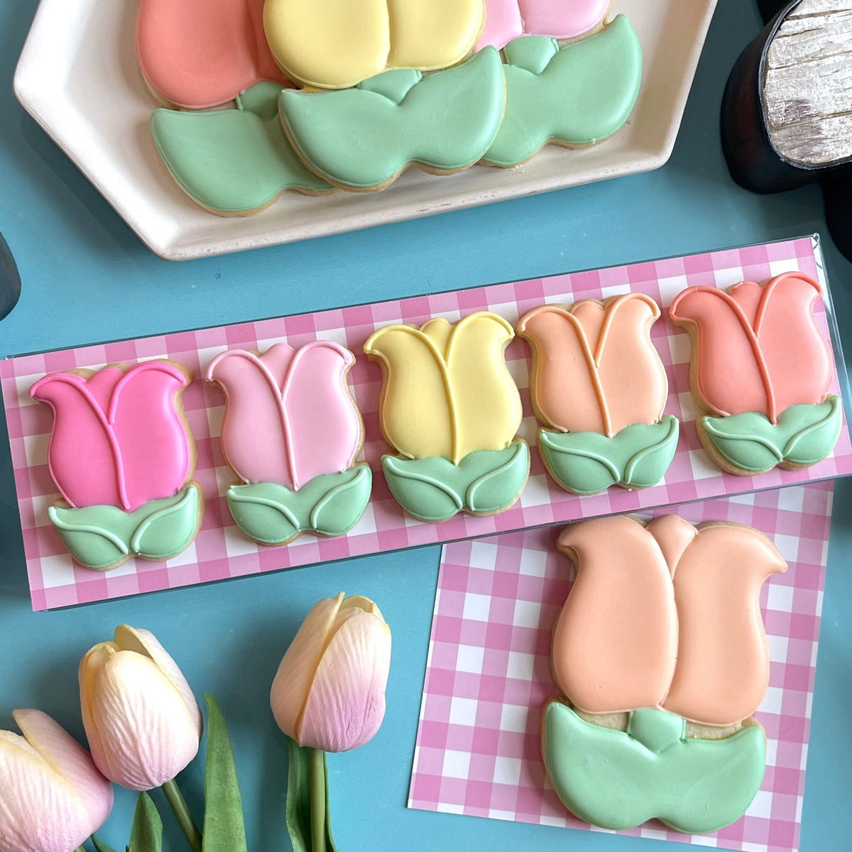 Mini easter cookie cutter bundle featuring pastel-colored tulip-shaped sugar cookies with smooth glossy icing