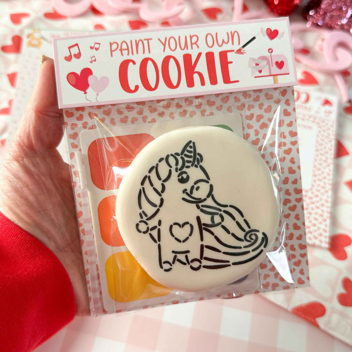 A white round paint your own cookie with a black unicorn outline and i heart k design vday hearts topper backer qty 25