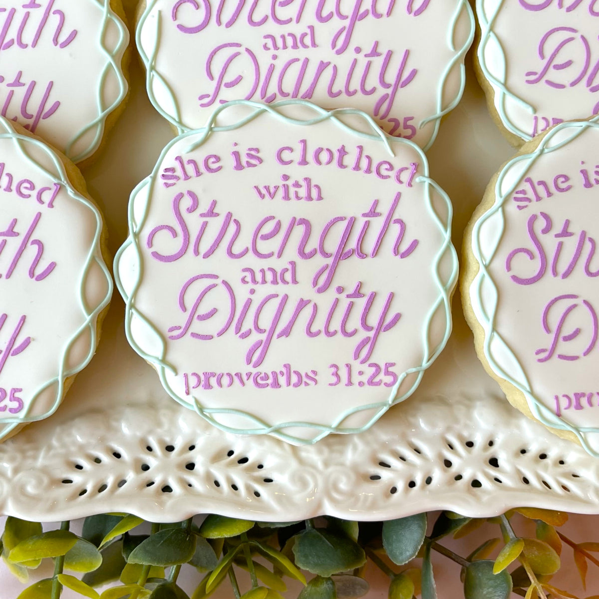 Proverbs 31 25 cutter and stencil bundle featuring white frosted cookies with lavender script and mint green border