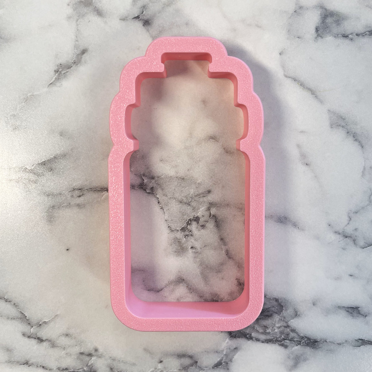 Pink glittery silicone sport water bottle cookie cutter shaped like a perfume bottle for baking use