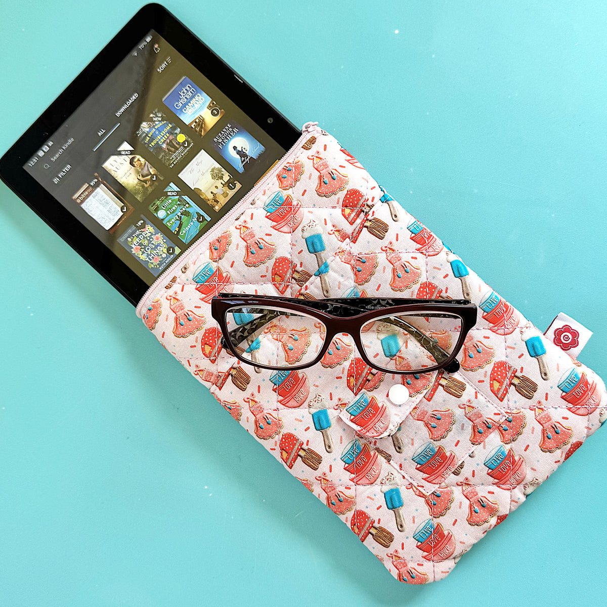 Pink quilted padded book sleeve 6 x 8 with red and blue ice cream cone pattern holding an amazon kindle device