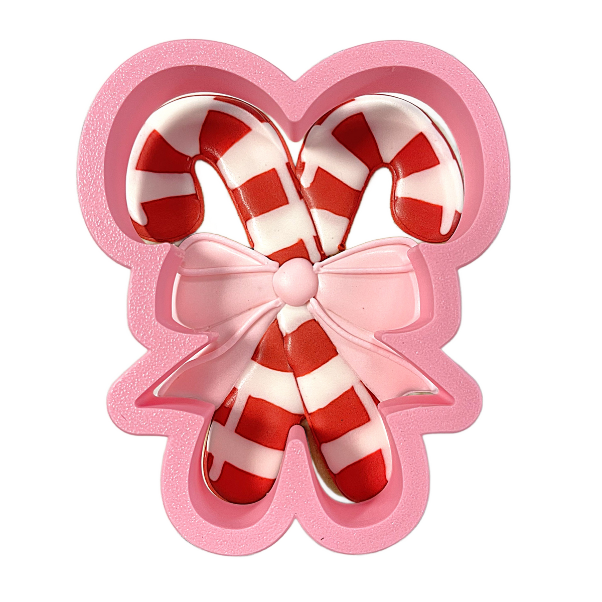 Pink silicone candy cane mold with red and white striped design for candy canes with bow cookie cutter