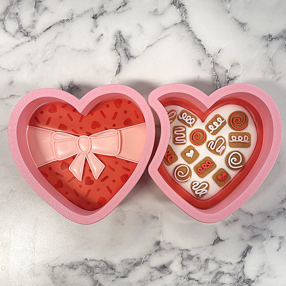 Pink heart-shaped glossy chocolate box with decorative bow filled with miniature chocolate candies for cookie cutter set
