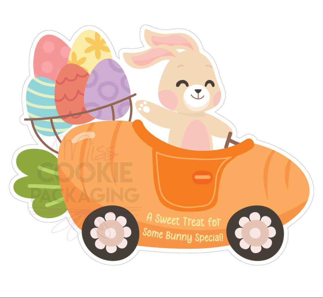 Bunny car die cut cookie card 6.5 x 5.125 with cheerful beige bunny driving orange carrot car carrying pastel easter eggs basket