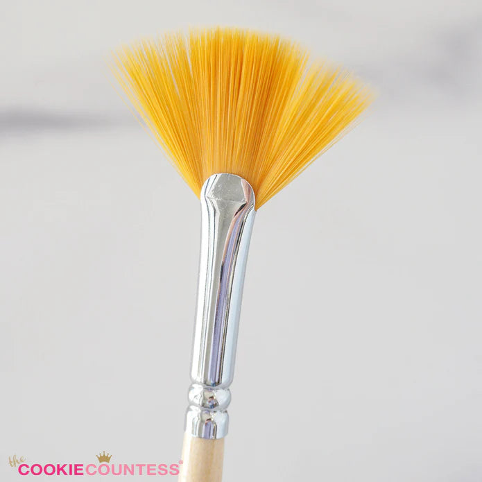 A vibrant yellow fan brush cookie countess brush with a sleek chrome ferrule and light wood handle