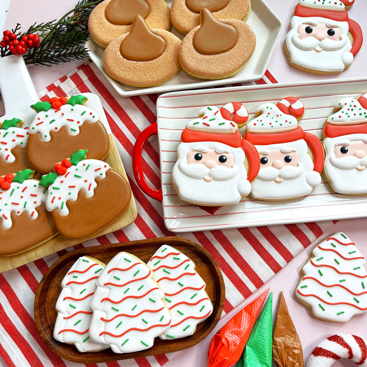 Christmas tree cake cookie cutter with christmas-themed sugar cookies decorated with white icing red and green sprinkles and candy cane accents