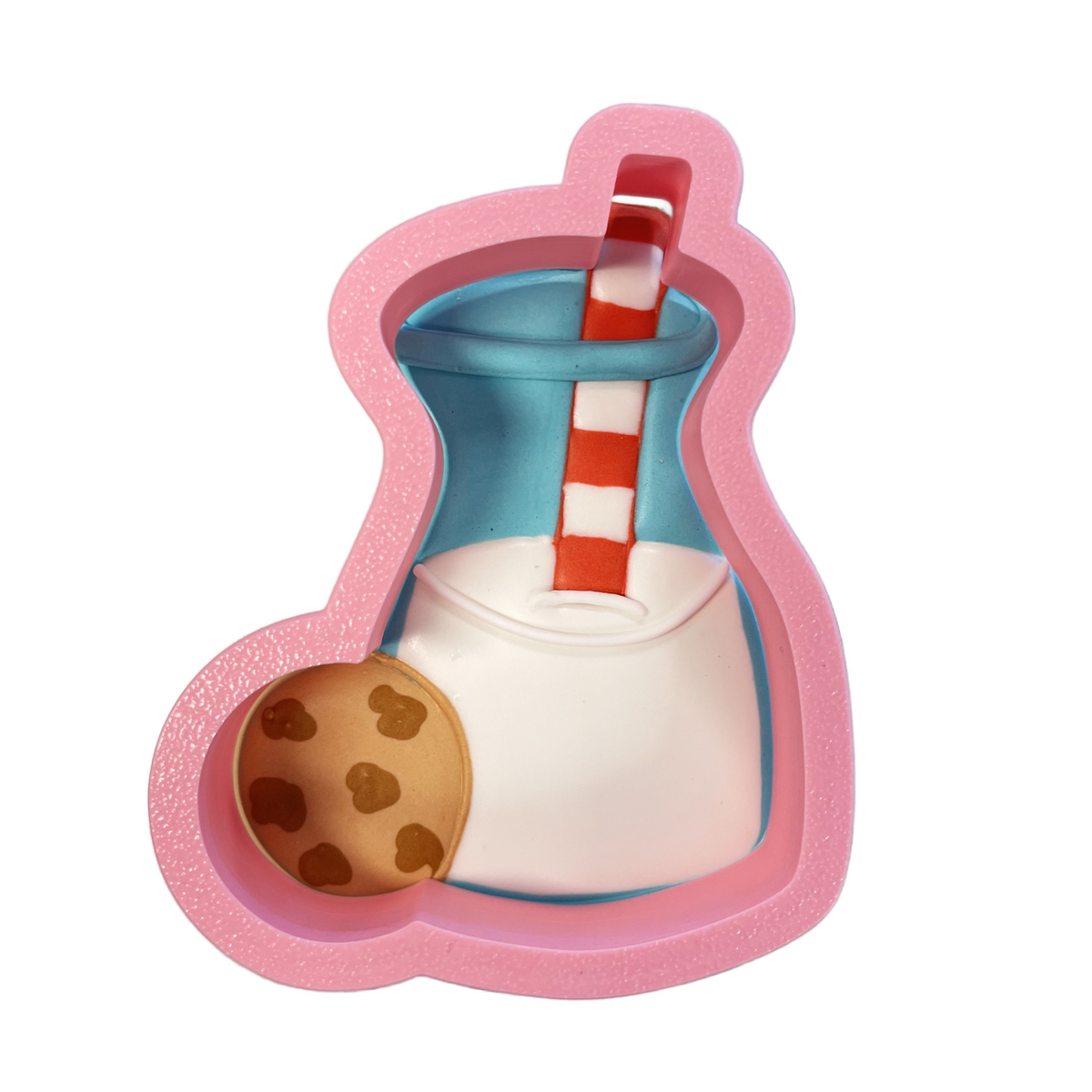 Pink silicone milk bottle cookie cutter shaped like milkshake cup with red and white striped straw and chocolate chip cookie