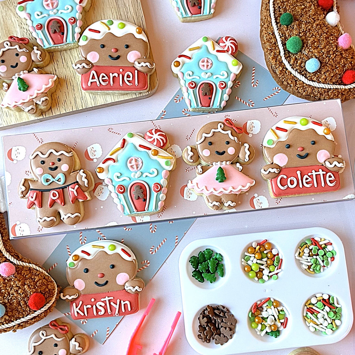 Mini christmas gingerbread cookie cutter bundle with smiling gingerbread men and women decorated with colorful icing and sprinkles