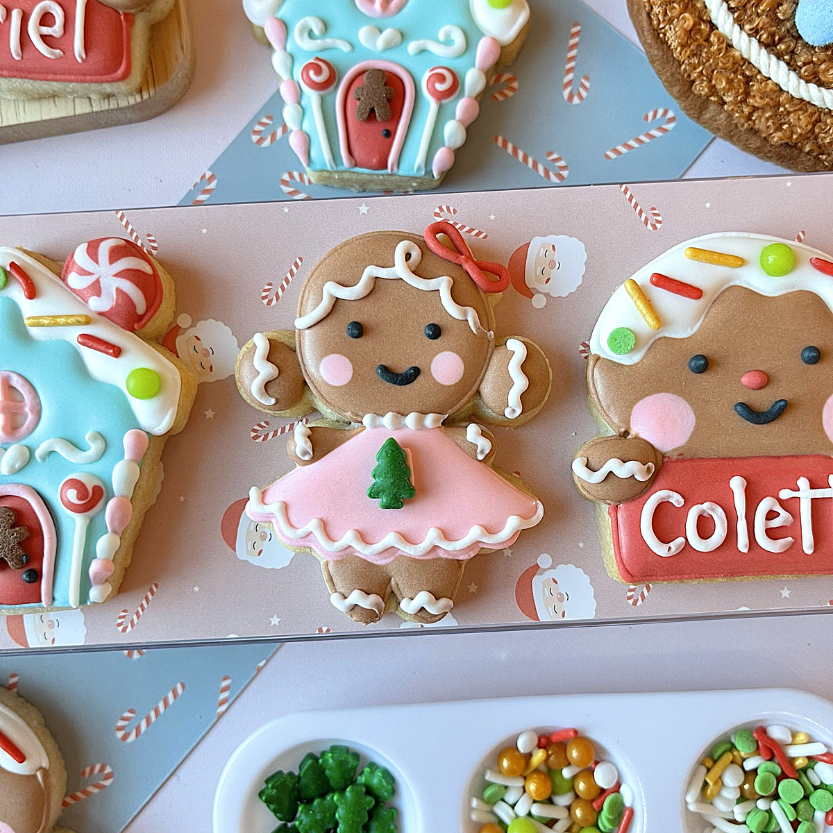 A charming gingerbread girl cookie with pink dress and white icing details from mini christmas gingerbread cookie cutter bundle