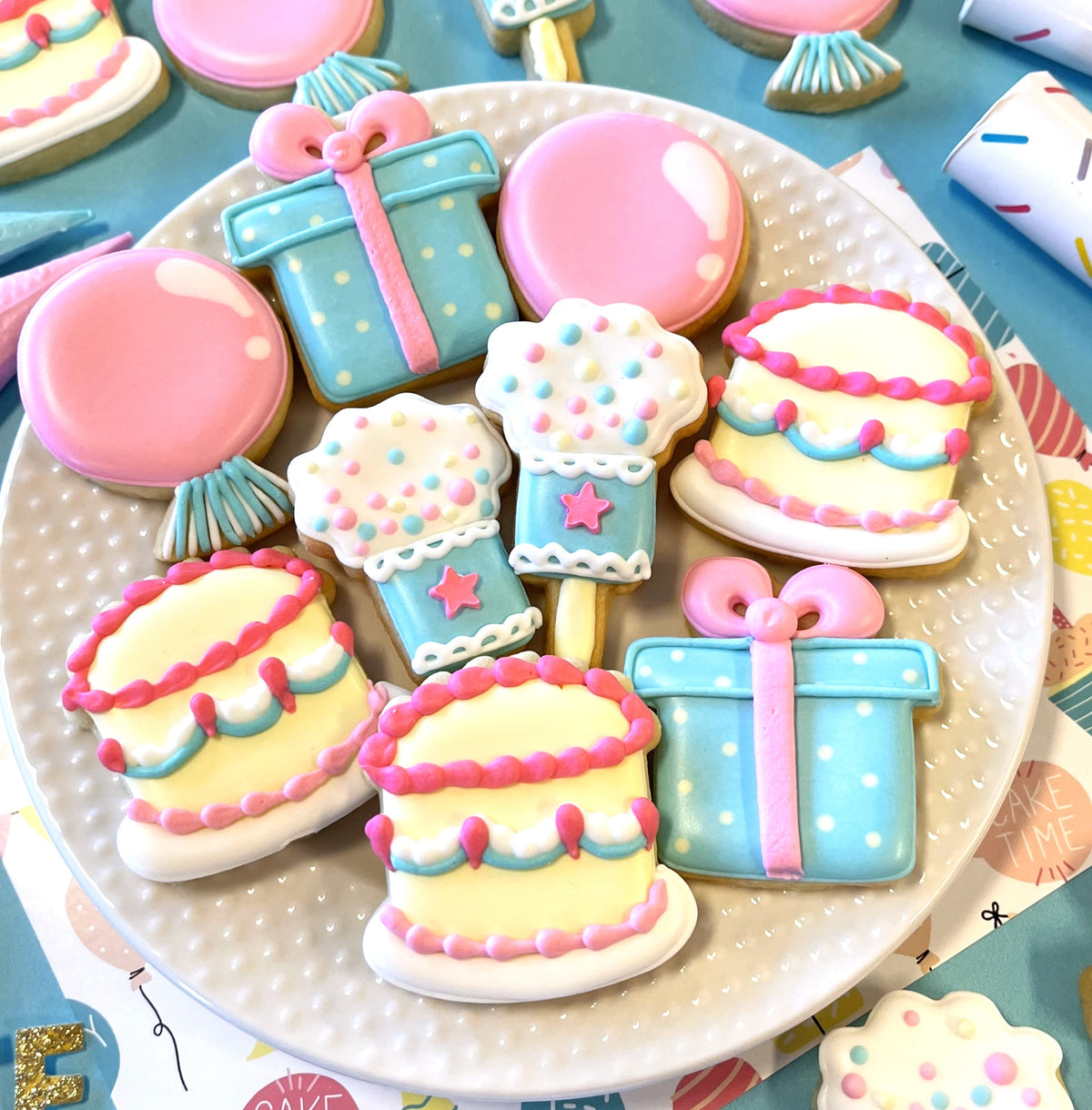 Mini birthday 4pc flour box club cookie cutter set with pastel blue and pink decorated sugar cookies shaped like cakes gifts and balloons