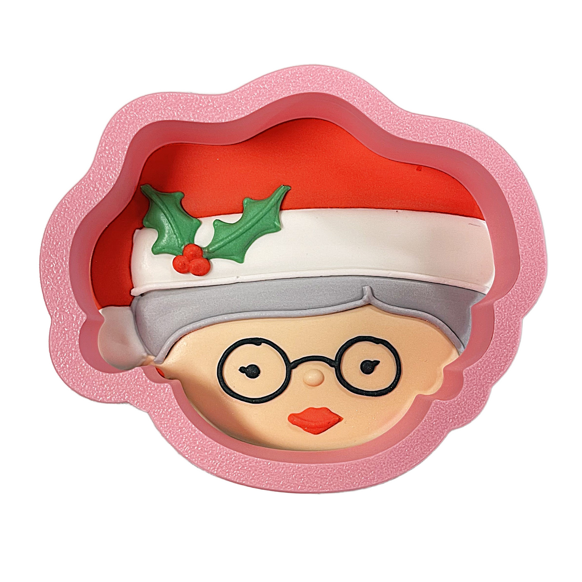 Pink silicone Mrs Claus with Santa hat cookie cutter shaped like a festive face wearing glasses and holly