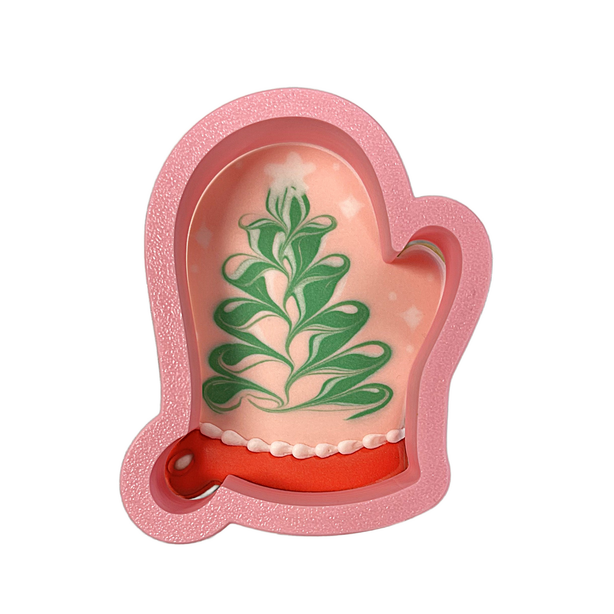 Pink glittery oven mitt shaped cake with green leaf design and red base made with oven mitt cookie cutter
