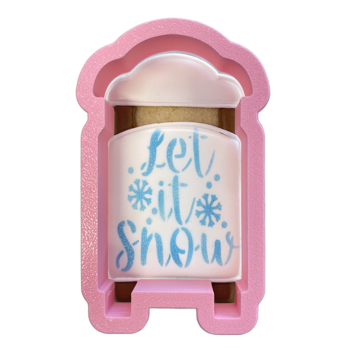 Pink glittery silicone sleigh flour box club cookie cutter shaped like a coffee cup with let it snow blue lettering and snowflakes