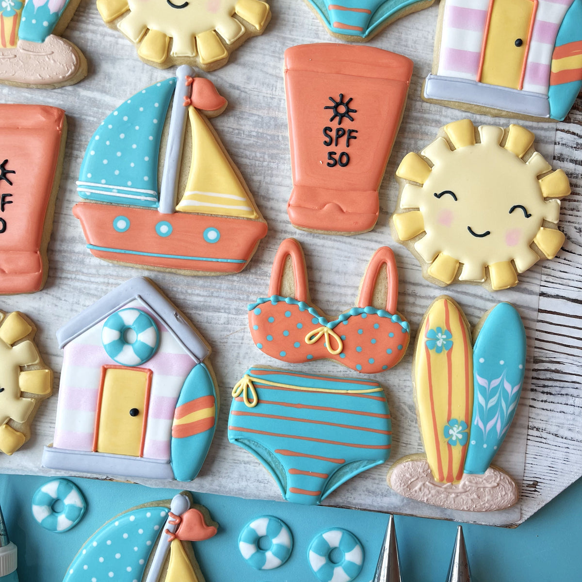 Beach Hut Cookie Cutter sugar cookie shaped like a bikini top with orange and blue polka dots and yellow ribbon ties