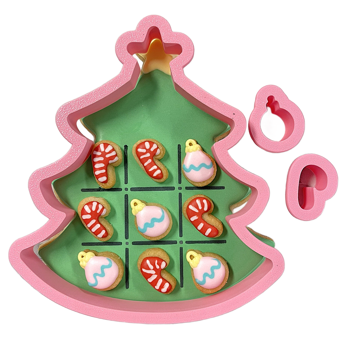 Pink christmas tree shaped cookie cutter with candy cane and ornament designs green interior gold star topper from tree tic tac toe cookie cutter set
