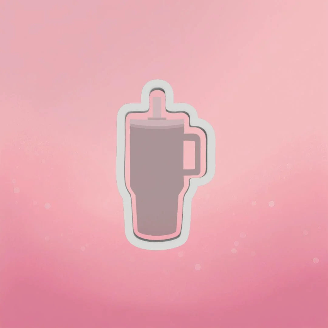 Gray insulated tumbler with handle and lid outlined in white on pink background for trendy tumbler cookie cutter