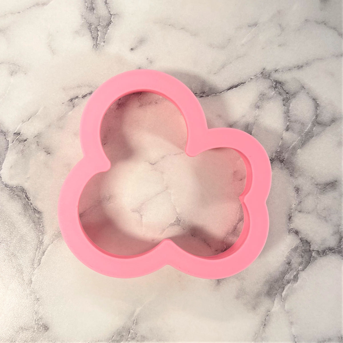 Pink silicone ampersand cookie cutter shaped like a cloud for baking and decorating cookies