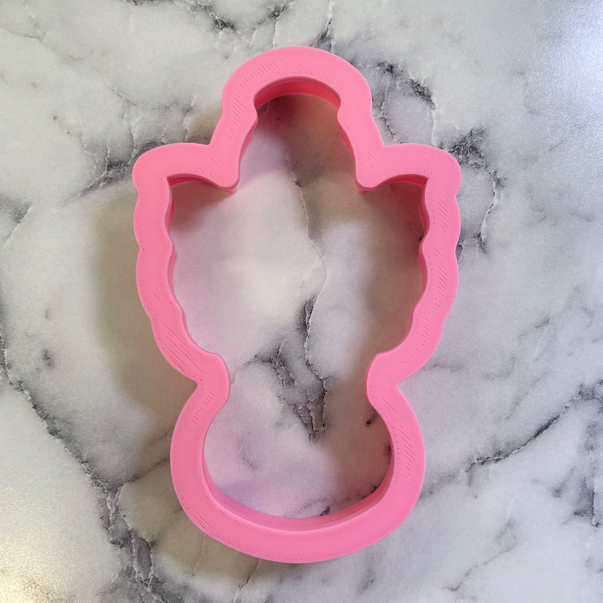Pink silicone christmas angel cookie cutter shaped like an angel for festive holiday baking