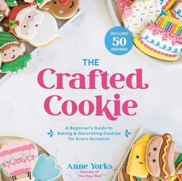 The Crafted Cookie book by Anne Yorks with vibrant pink and teal text and colorful decorated cookies on white background