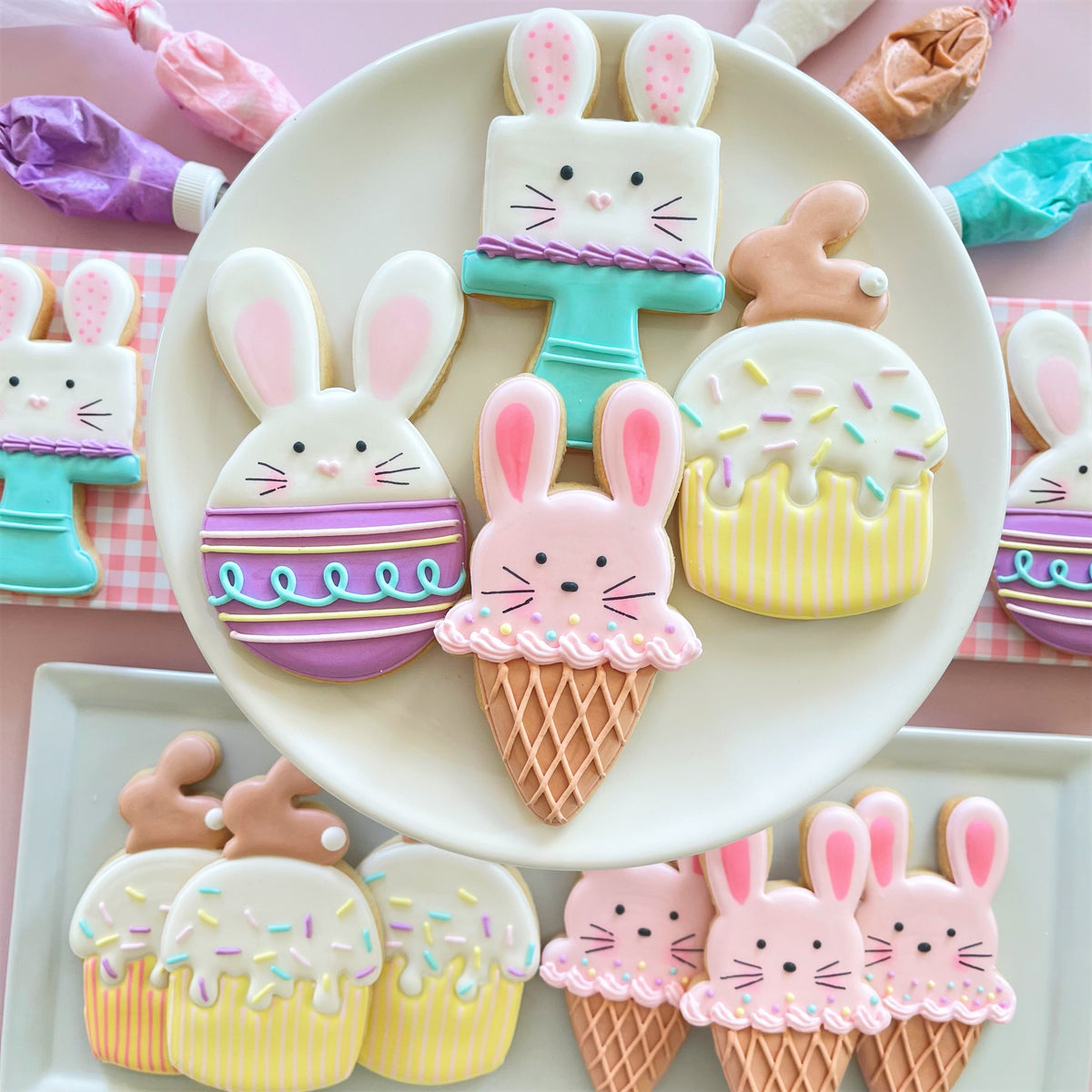 Pastel-colored easter-themed sugar cookies shaped like bunnies cupcakes and ice cream cones made with bunny muffin cookie cutter