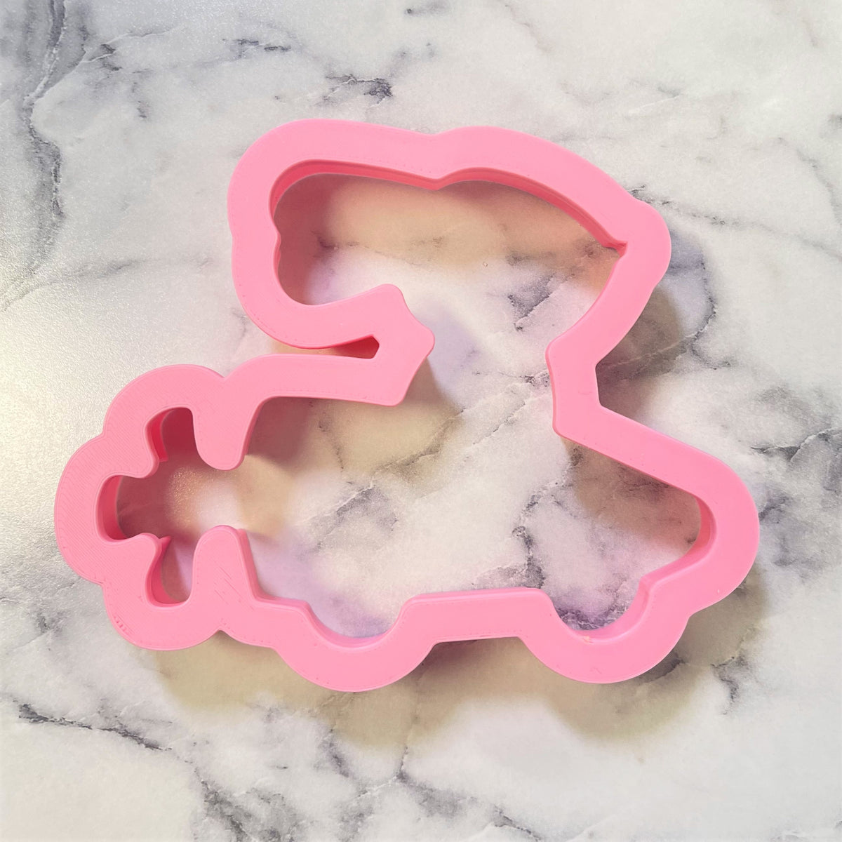 Pink silicone cookie cutter shaped like a princess in a gown from bunny in carrot car cookie cutter product line