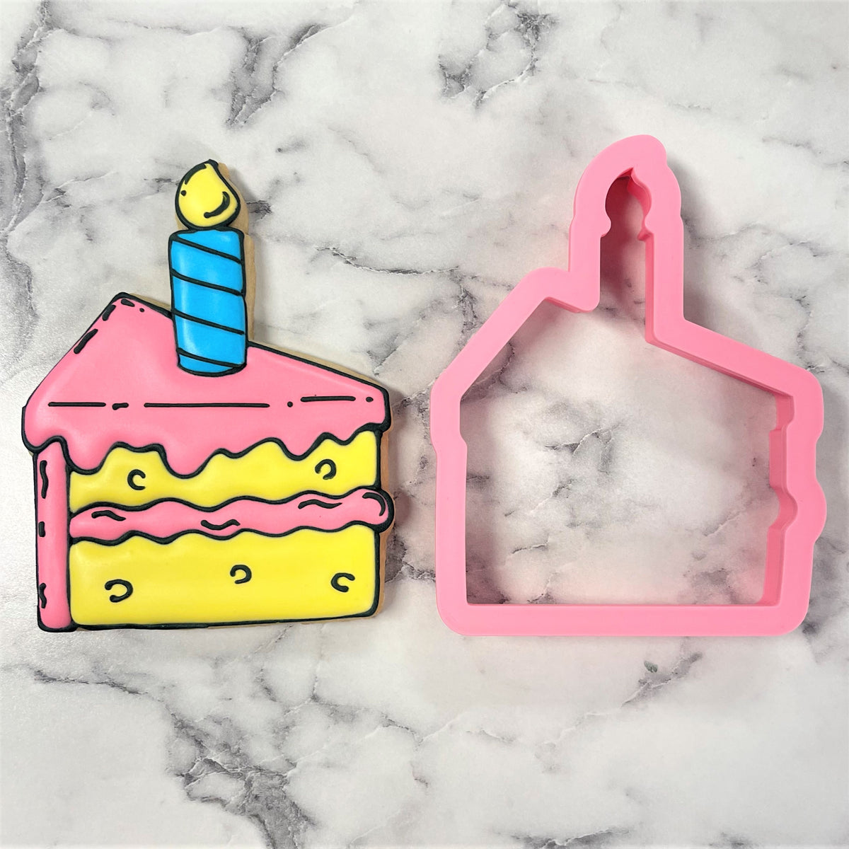 Pink plastic cookie cutter shaped like a birthday cake with a blue candle for cake slice cookie cutting