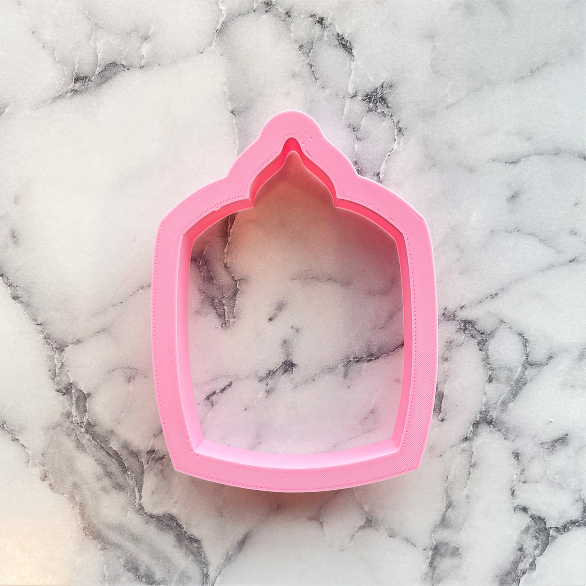 Pink silicone cookie cutter shaped like a house with arched top for candle glass jar crafts and baking use