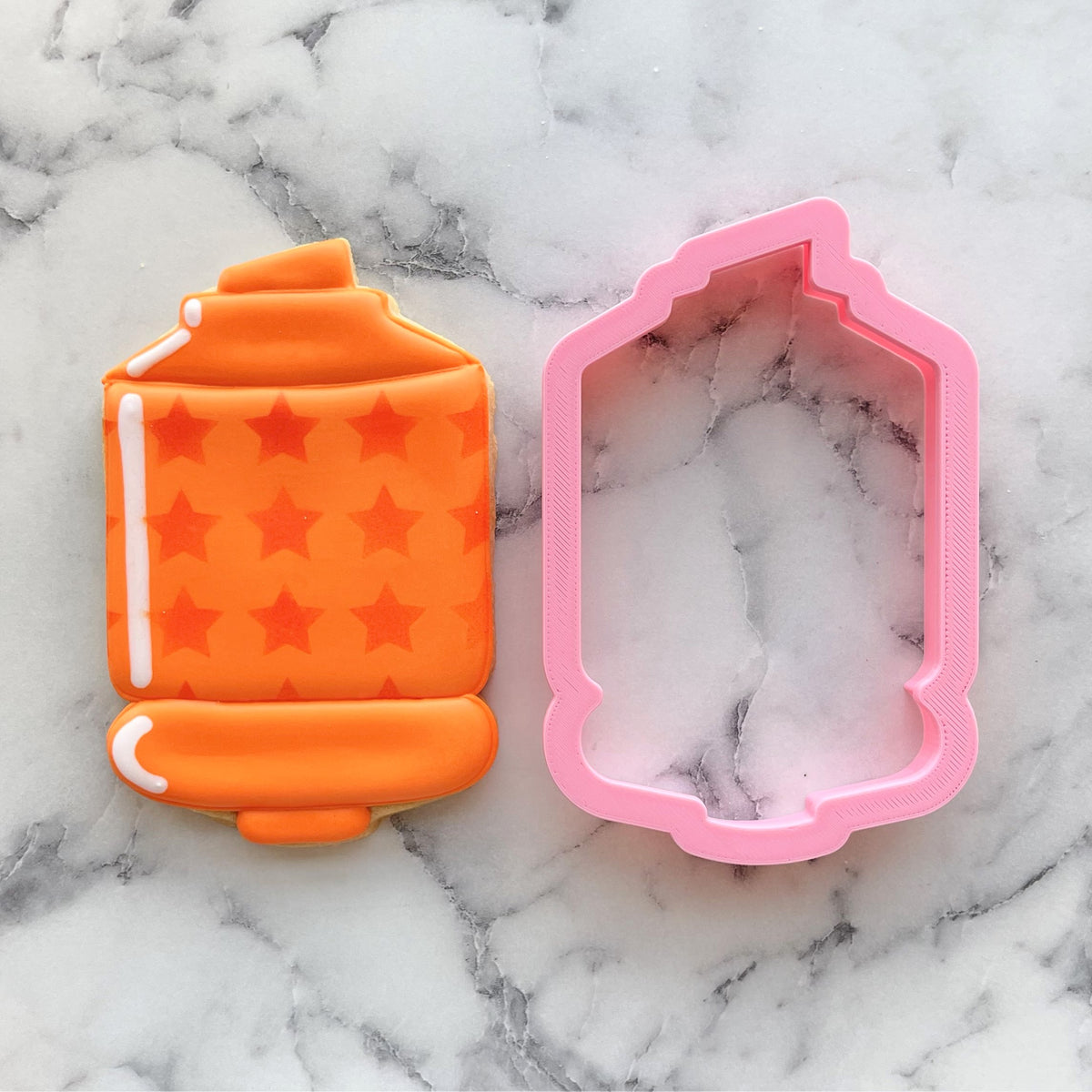 Orange star-patterned lantern cookie with pink silicone mold using chubby xl highlighter cookie cutter for baking
