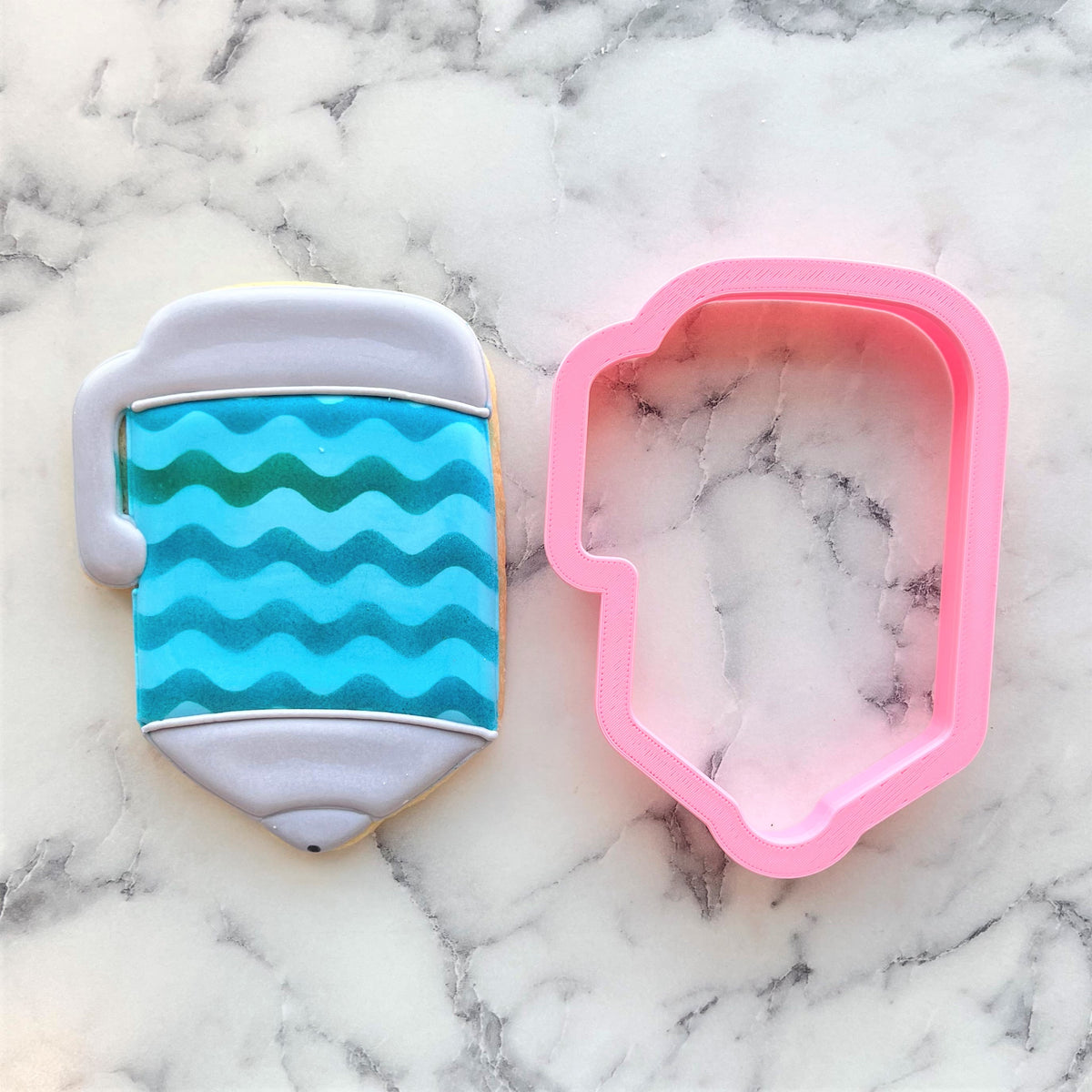 Chubby xl pen cookie cutter shaped cookie resembling a mug with blue and green wavy stripes and gray handle
