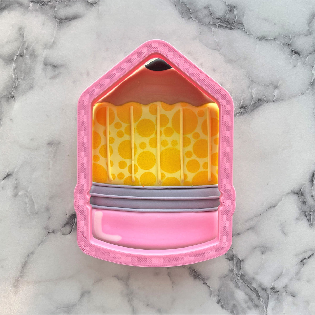 Chubby xl pencil cookie cutter shaped pink soap dish with yellow bubble interior and gray rubber bands