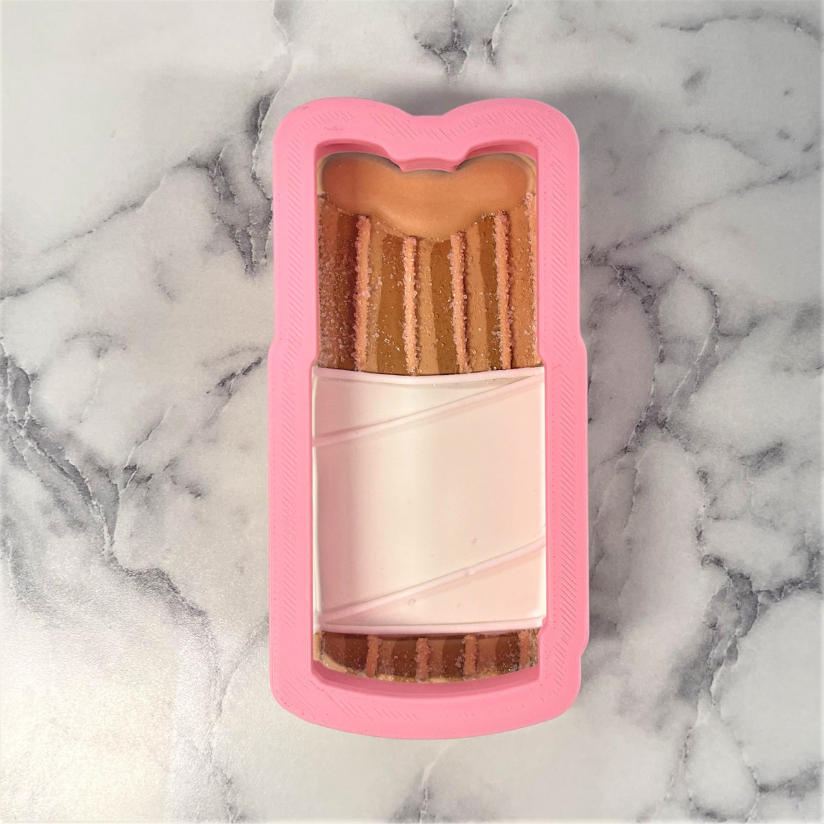 Pink silicone churro cookie cutter mold shaped like smartphone case with chocolate ice cream bar design and sprinkles