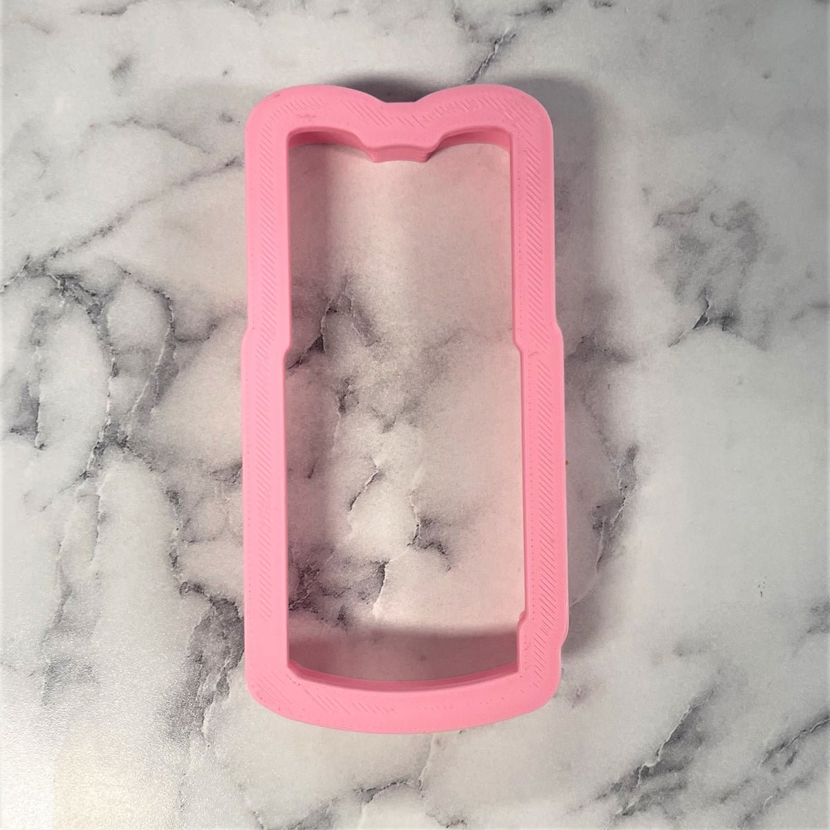 Pink silicone phone case with cat ear design shown from the back for churro cookie cutter product