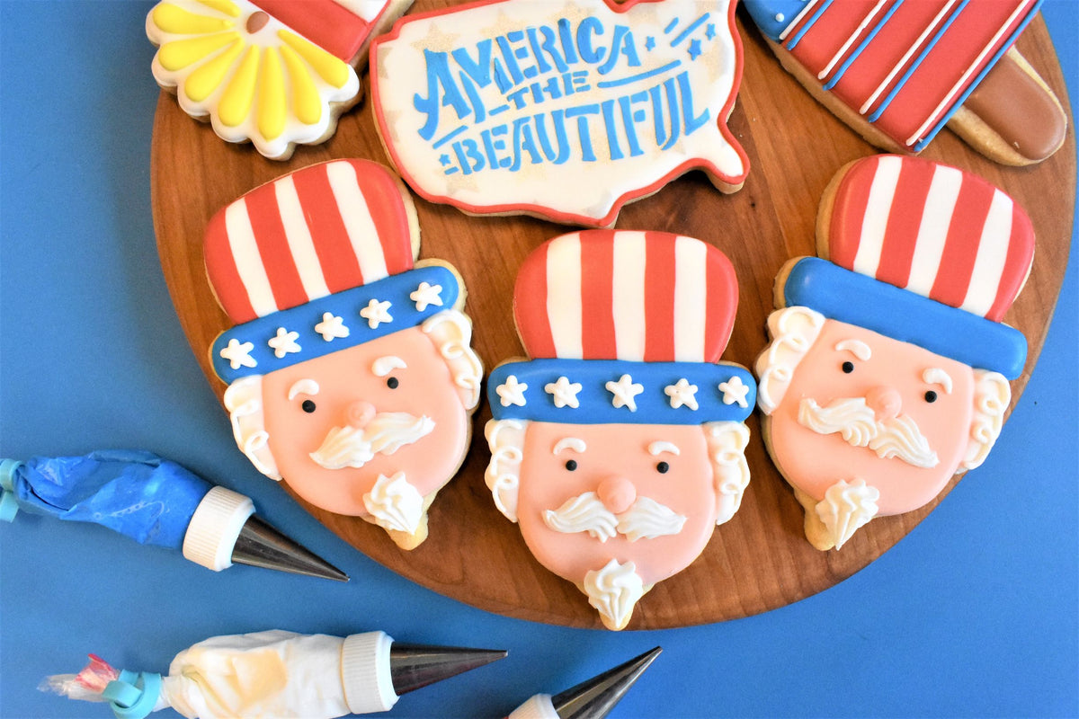 Uncle sam gnome cookie cutter with red white and blue frosted sugar cookies shaped like uncle sams face and hat