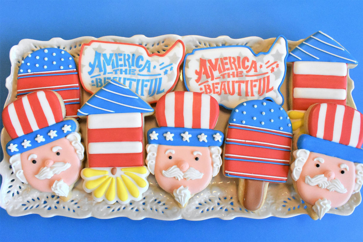 Patriotic red white and blue sugar cookies shaped like uncle sam and american flags made with uncle sam gnome cookie cutter