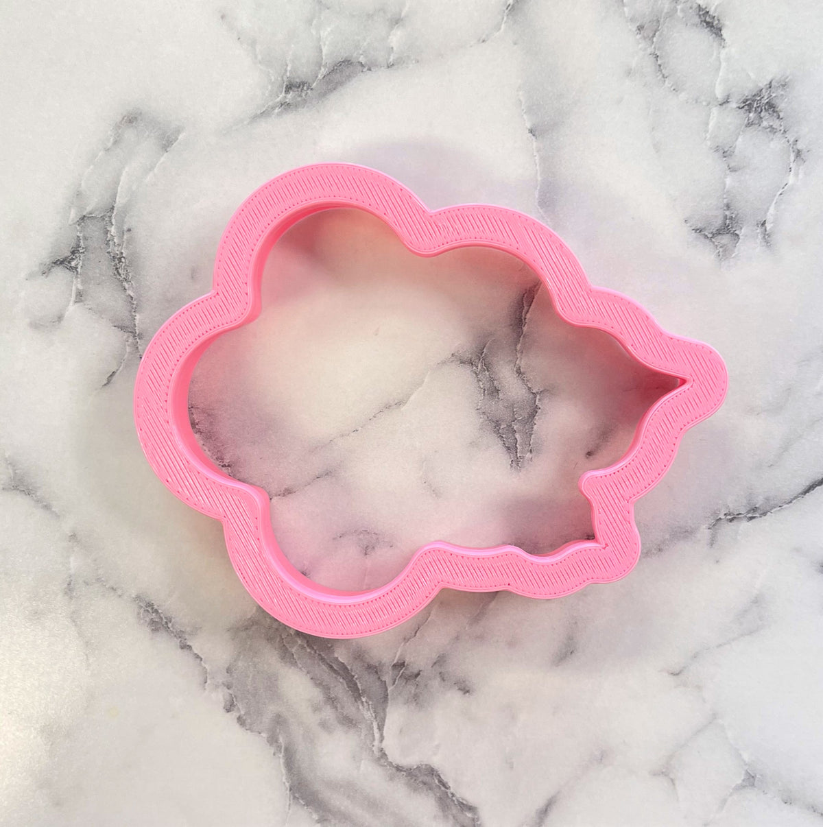 Pink cloud-shaped metal cookie cutter from the daisy with leaves cookie cutter set for baking and decorating