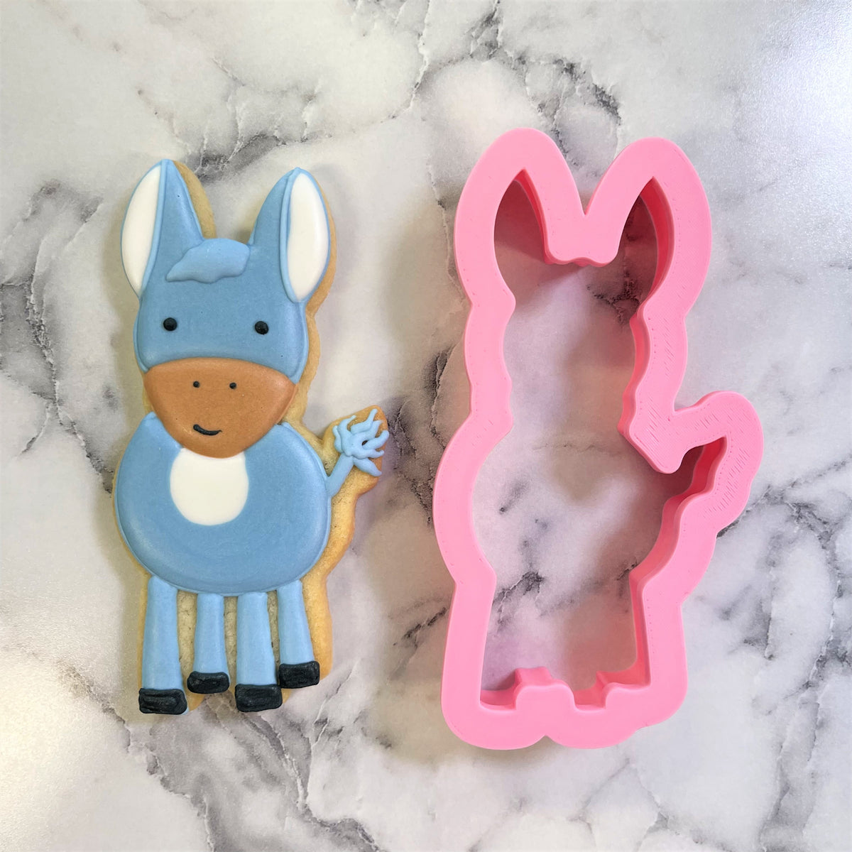 Pink silicone little donkey cookie cutter with smooth flexible surface and detailed cutout shape for baking