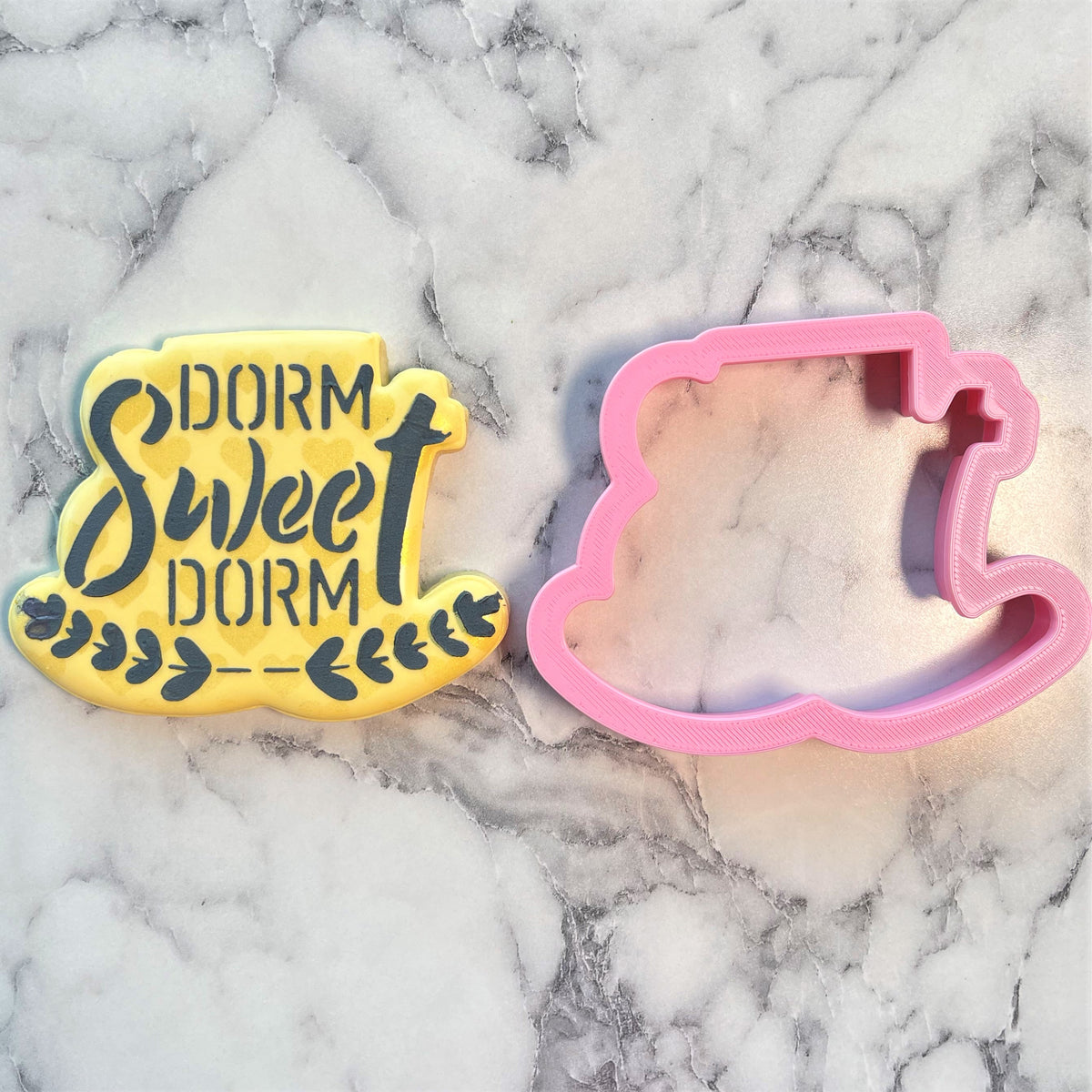 Yellow dorm sweet dorm plaque cookie cutter with black stencil lettering and pink rocking horse cookie cutter set