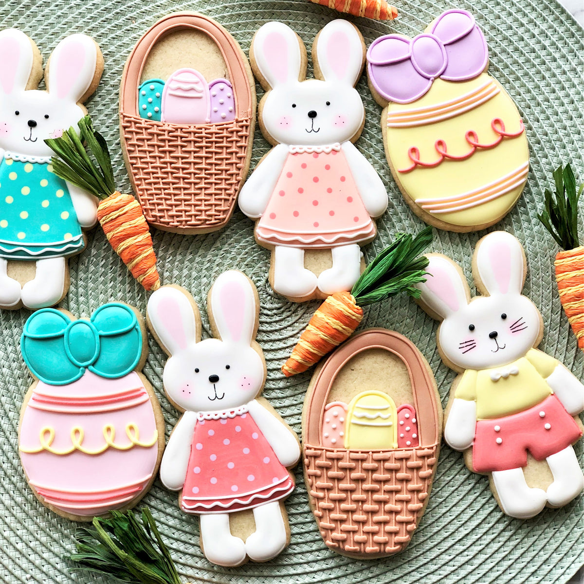 Pastel-colored easter-themed sugar cookies shaped like eggs with bows made using egg with bow cookie cutter