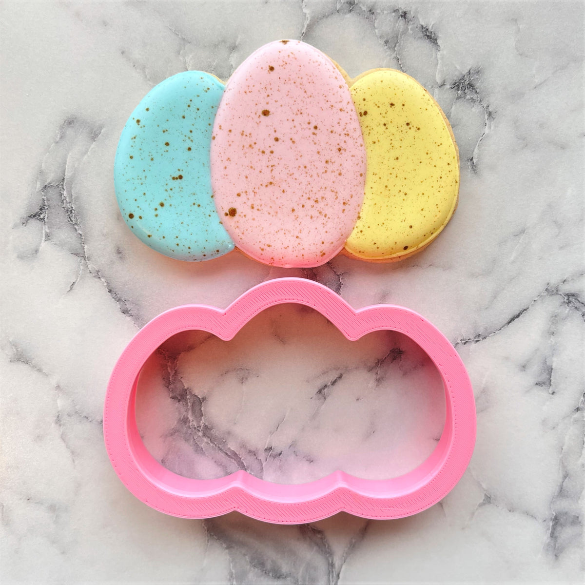 Pink cloud-shaped egg cluster cookie cutter made of durable plastic for baking and craft projects
