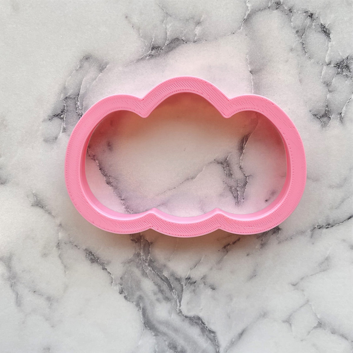Pink cloud-shaped egg cluster cookie cutter made of durable plastic for easy baking and decorating