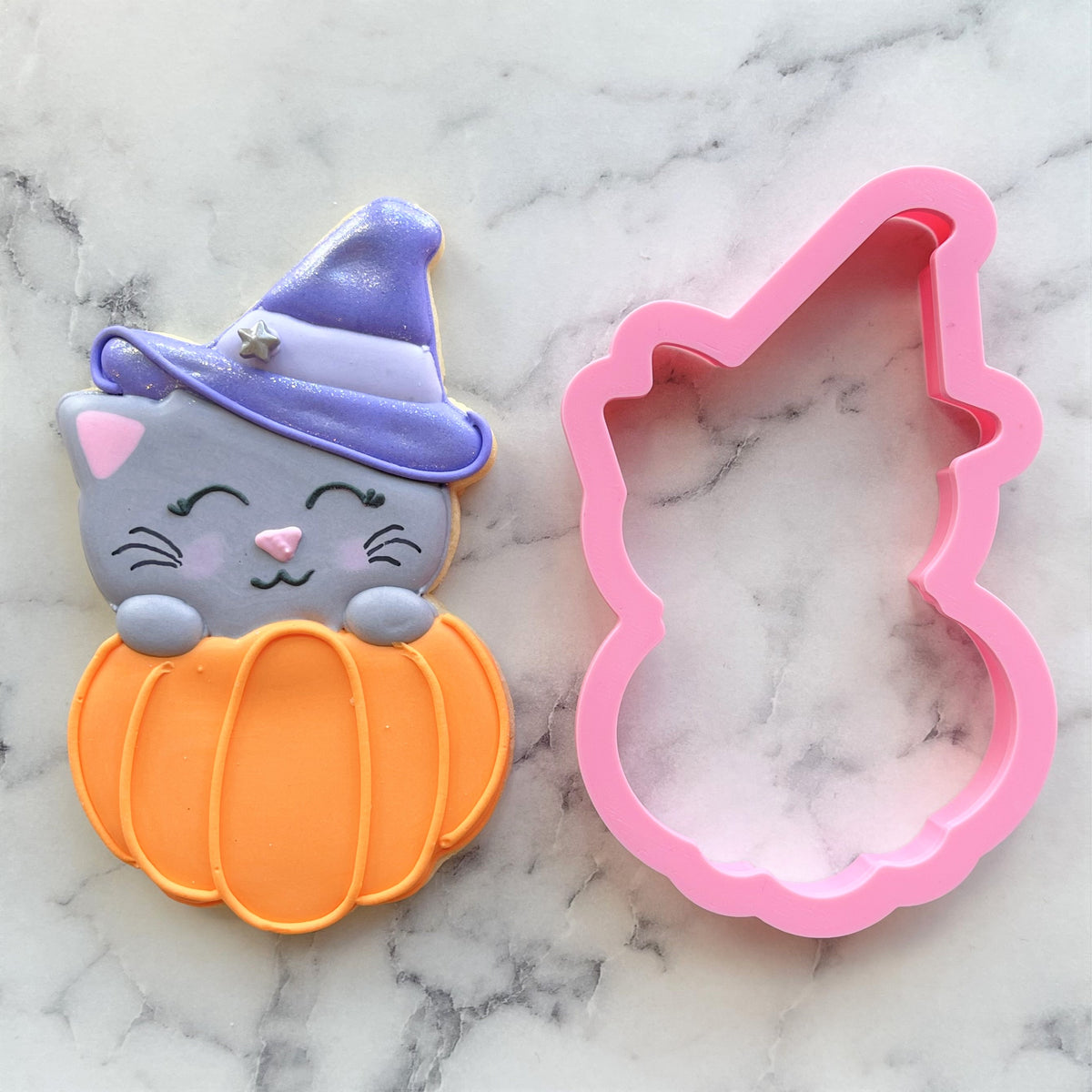 Pink silicone fab-boo-lous cat in pumpkin cookie cutter shaped like a cat wearing a wizard hat