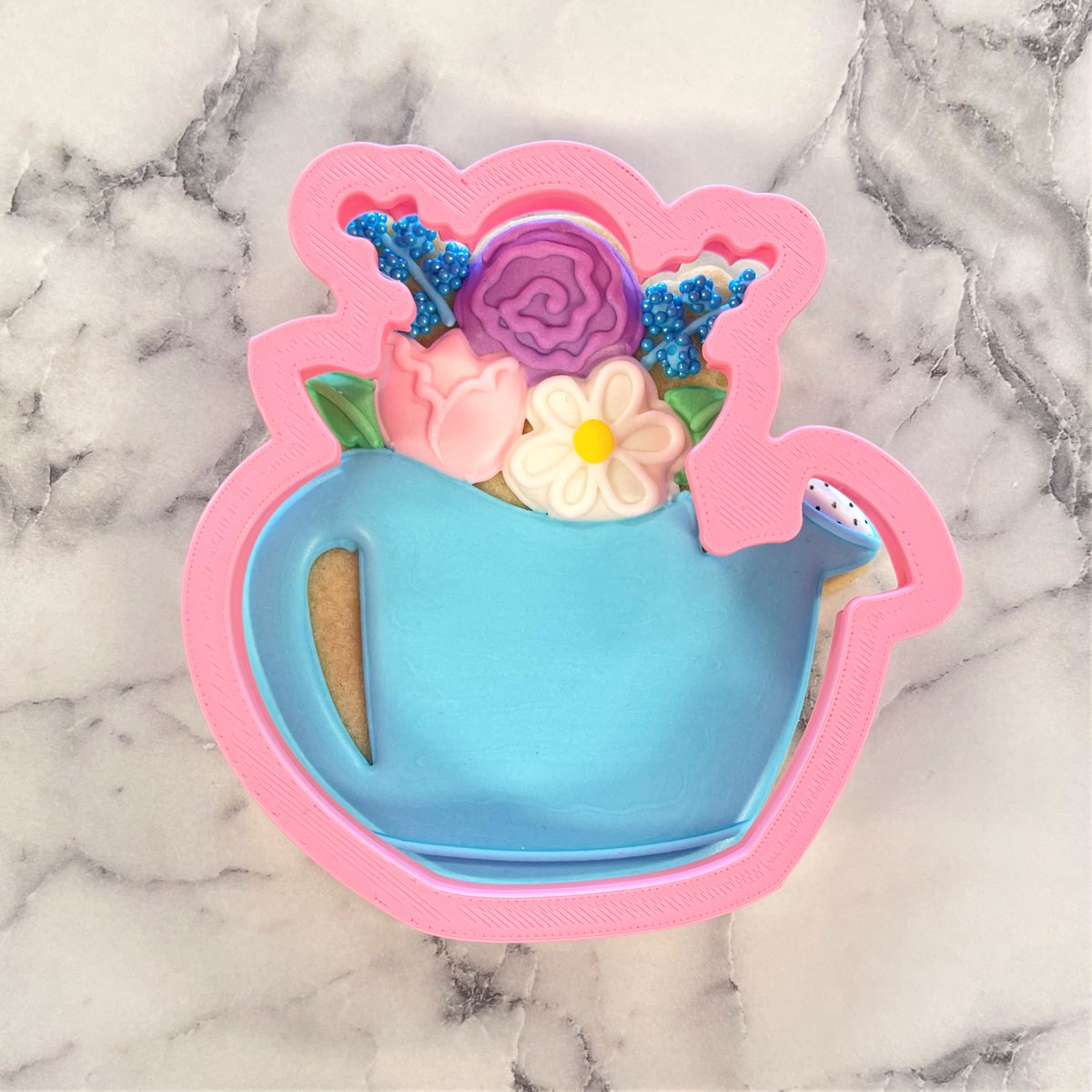Floral watering can flour box club cookie cutter in pink and blue plastic with colorful flower designs