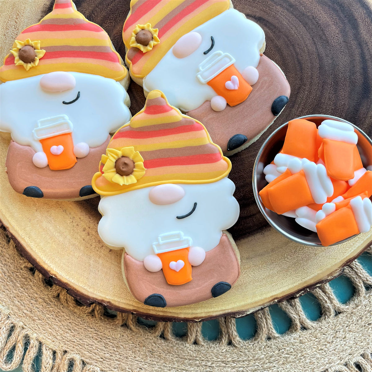 Cute orange and yellow striped gnome cookies with sunflower hats and coffee cup details made using uncle sam gnome cookie cutter