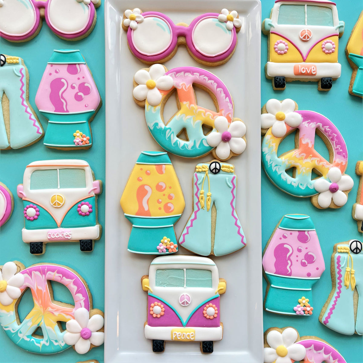 Groovy sunglasses cookie cutter creating pastel sugar cookies shaped like peace signs and vintage vans with icing flowers and tie-dye patterns