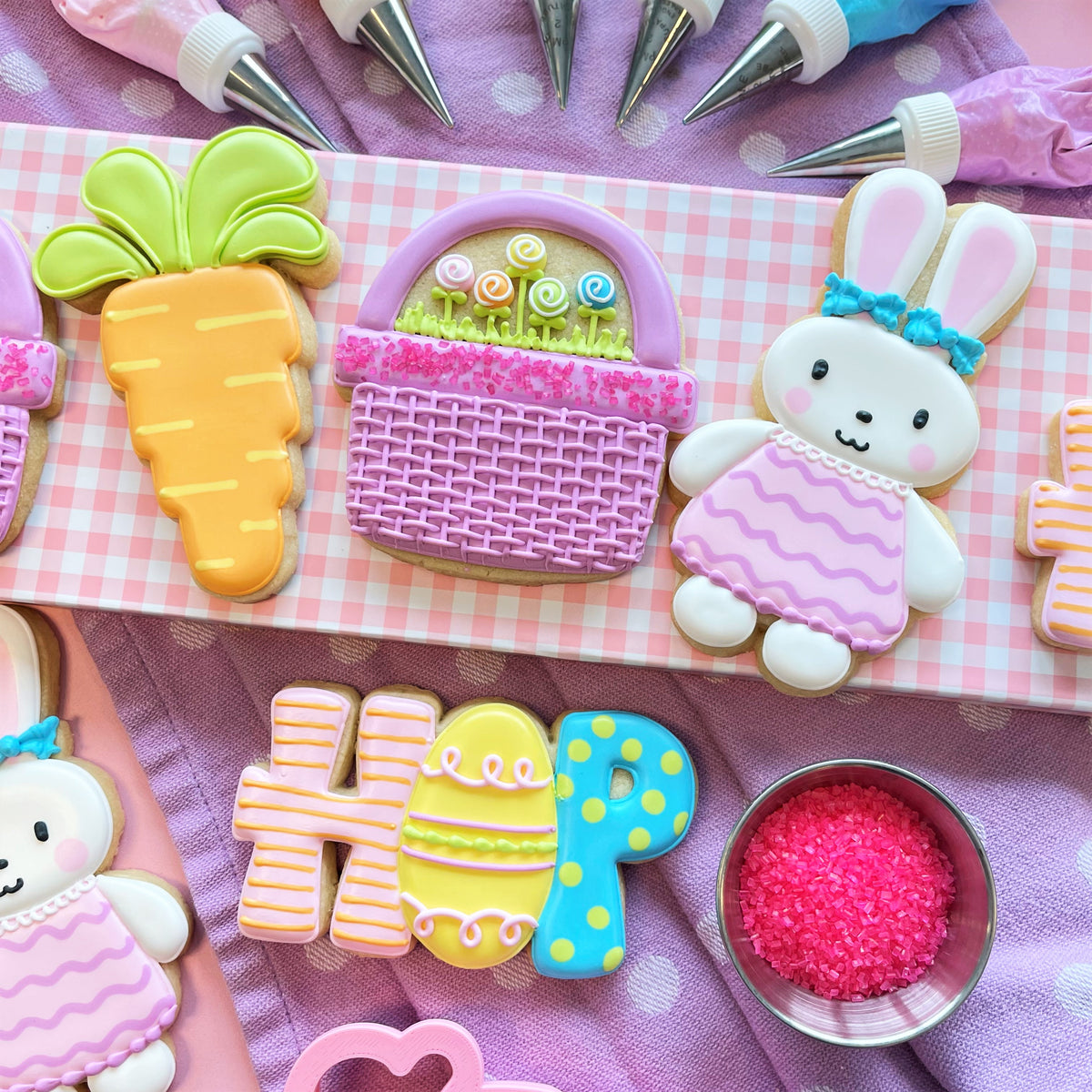 Pastel pink and purple woven basket cookie decorated with green grass and colorful lollipops for hop Easter cookie cutter bundle