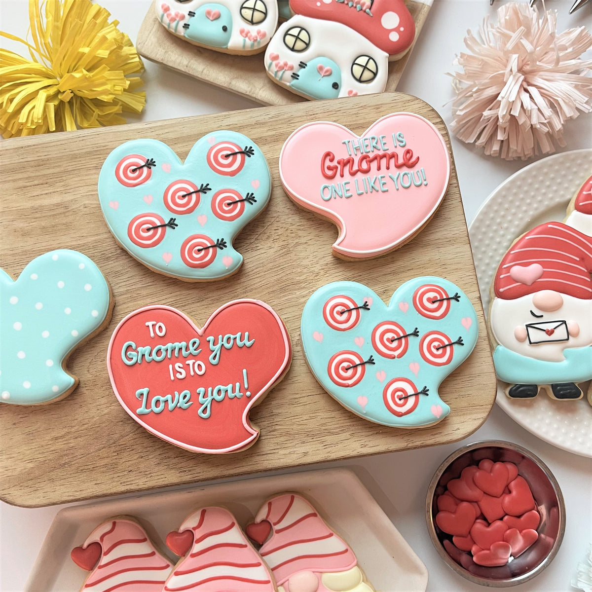 Pastel blue and coral heart-shaped cookies with pink target patterns and white polka dots from gnome cutter bundle